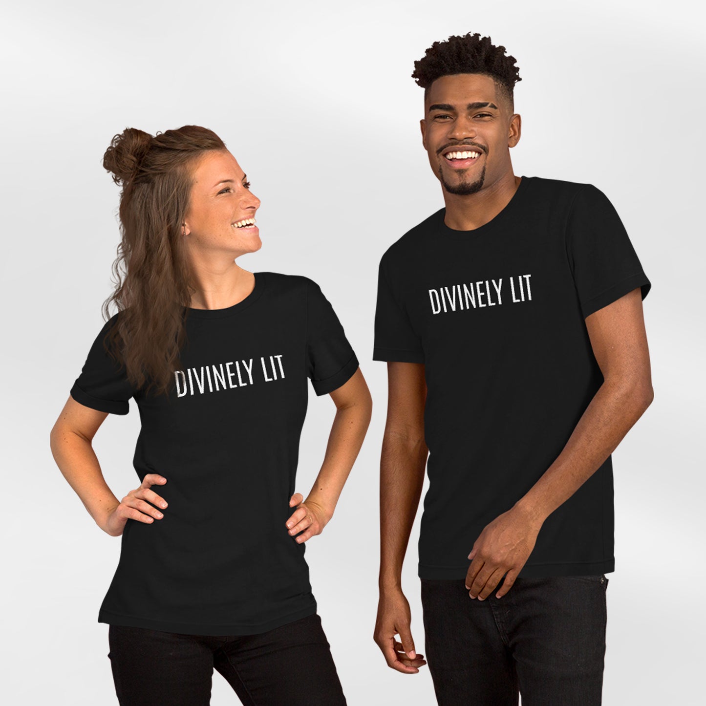 Couple wearing black t-shirts with 'DIVINELY LIT' text on a white background