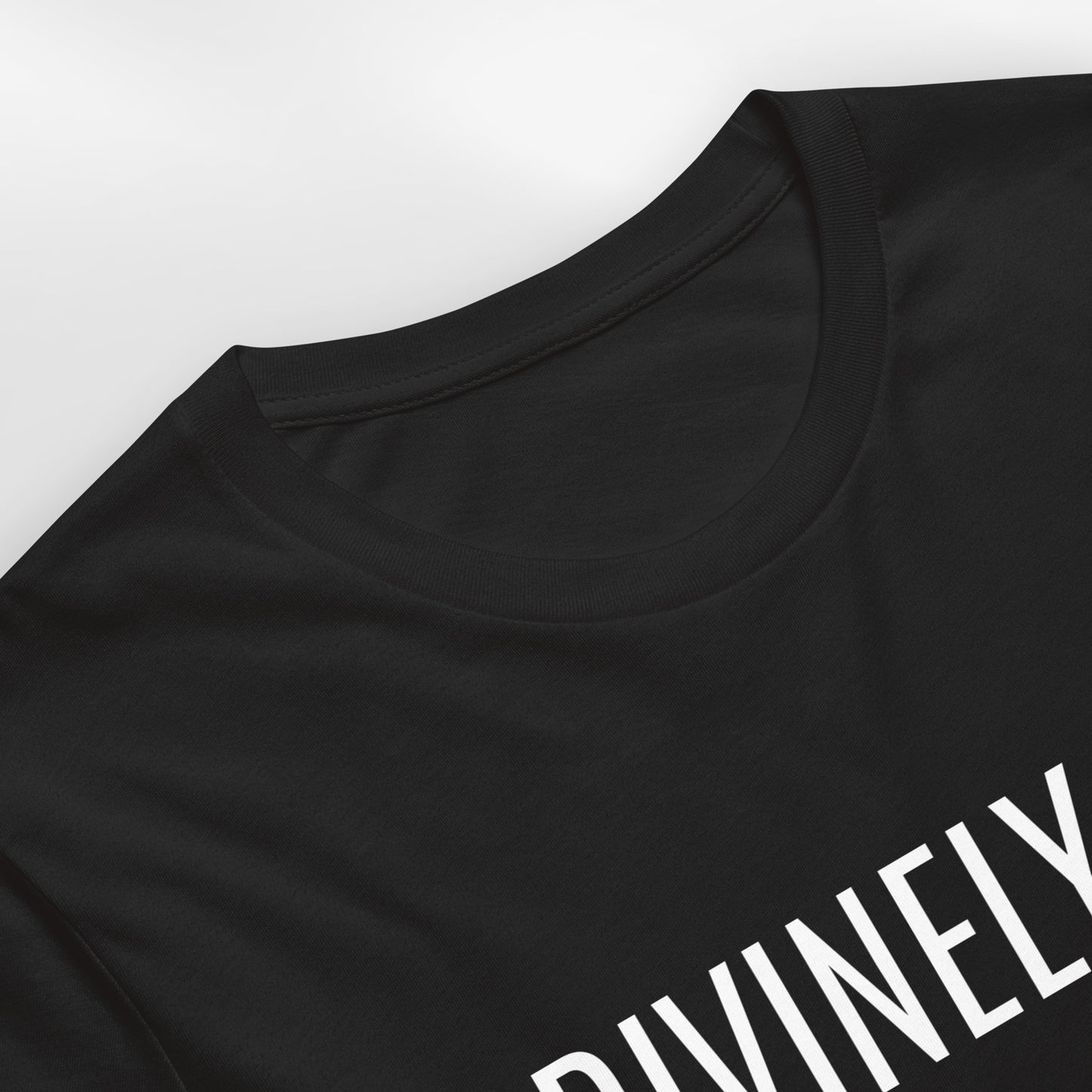 Black t-shirt with 'DIVINELY' text on a white background