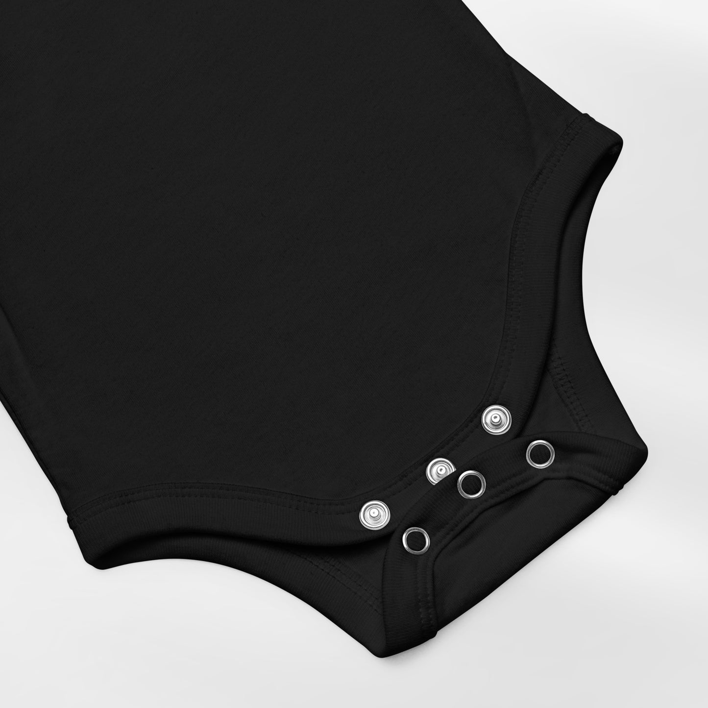 Black baby onesie with button details on a white background