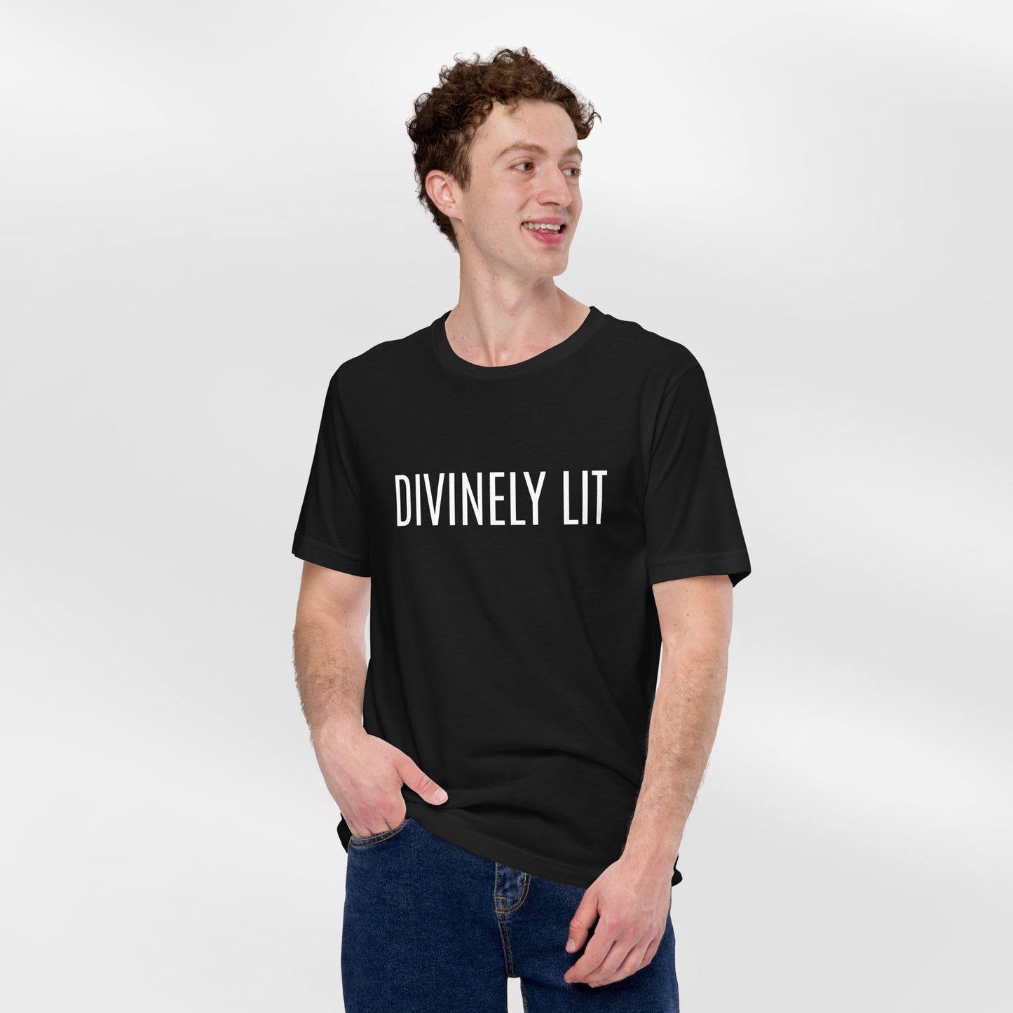 A man wearing a black t-shirt with 'DIVINELY LIT' text on a white background