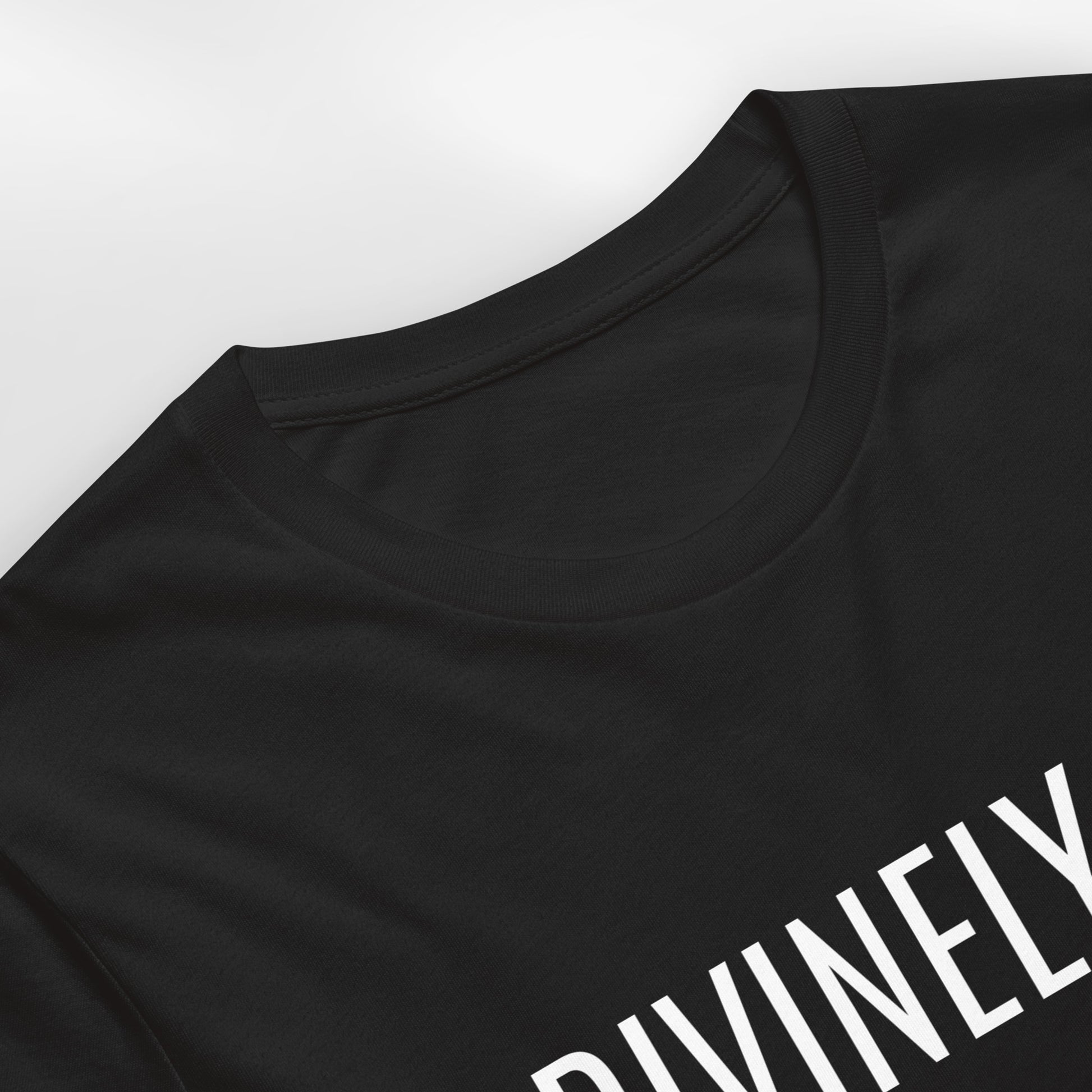 Black t-shirt with 'DIVINELY' text on a white background