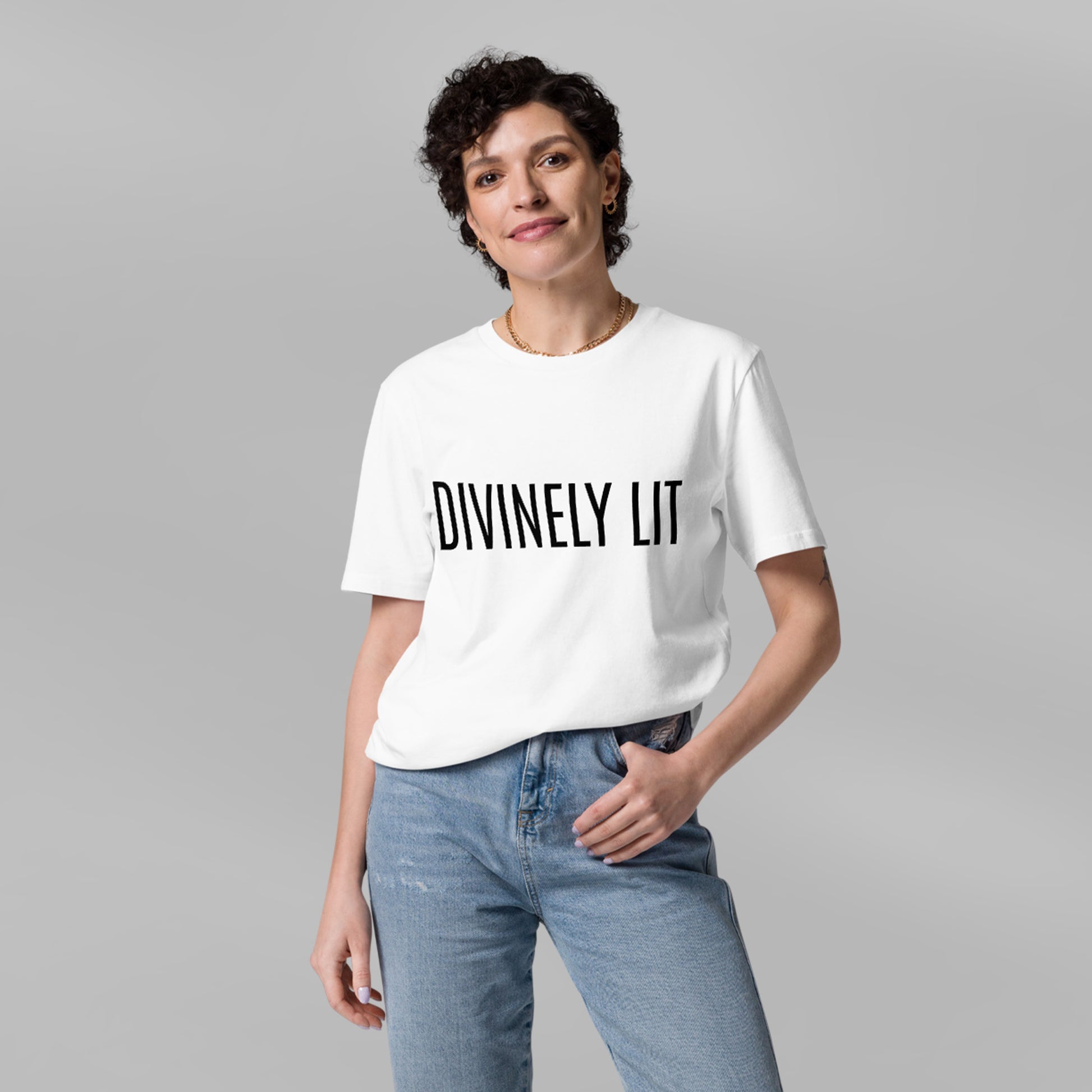 Person wearing a white t-shirt with 'DIVINELY LIT' text on a gray background